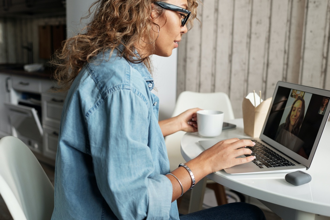 a woman having a coaching session on her laptop