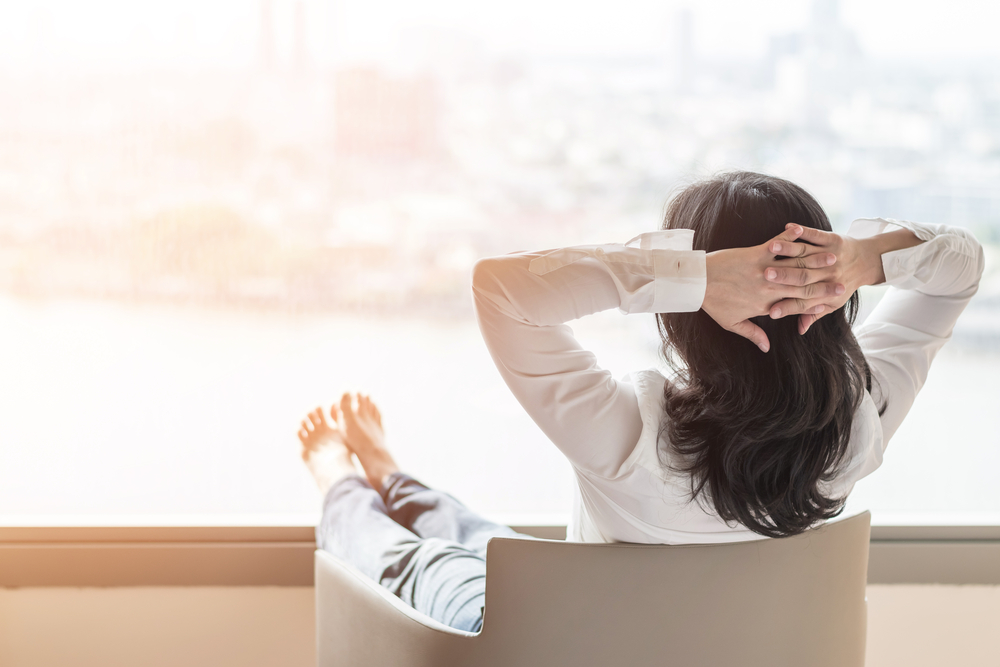 Woman looking out the window in an article on how to manage binge eating disorder from eating disorder recovery specialists.