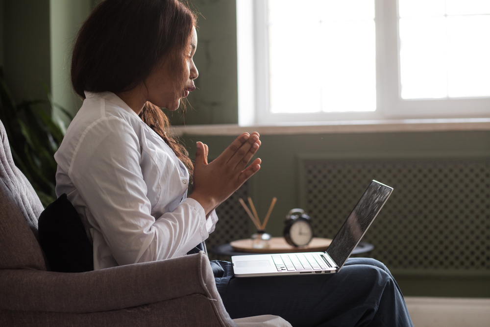 Woman talking on her laptop on eating disorder recovery specialists website on their IOP page